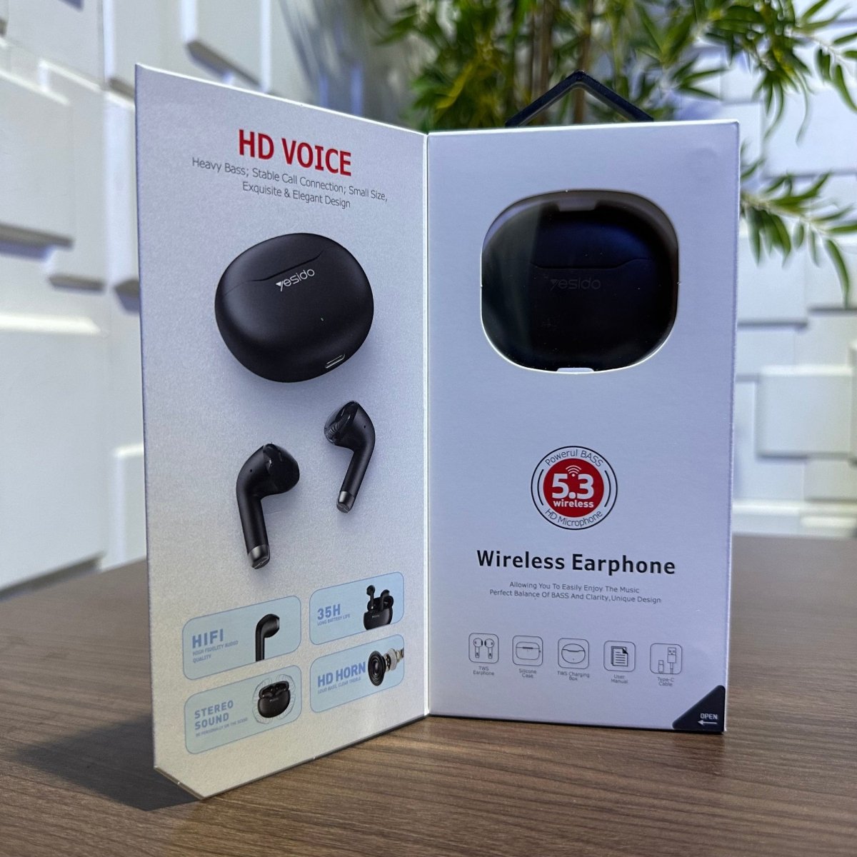 Wireless earphone packaging with earphones displayed on a wooden surface