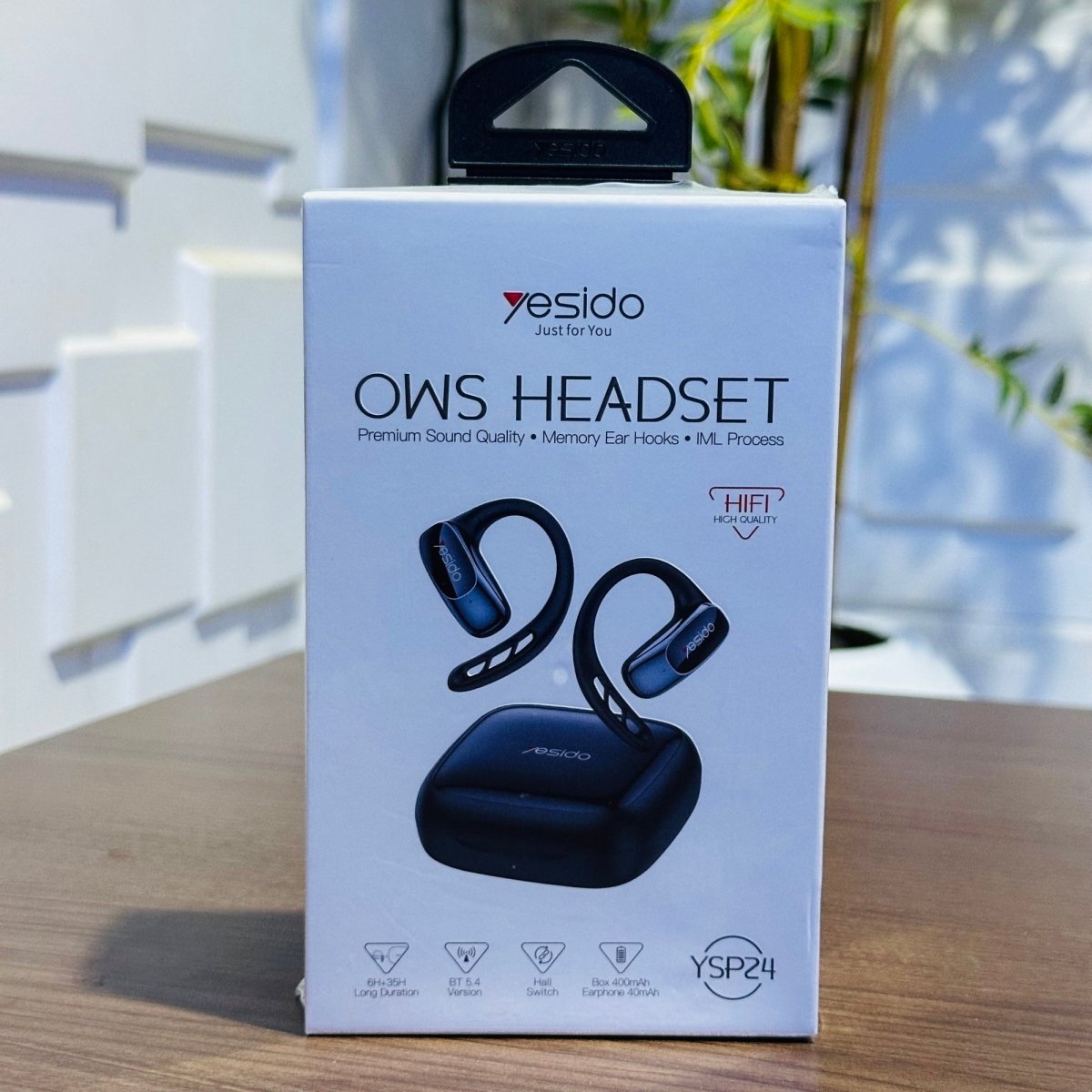 Yesido OWS Headset packaging on a wooden surface with a blurred background