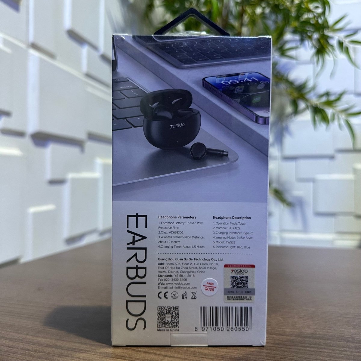 Box of earbuds on a wooden surface with a blurred background