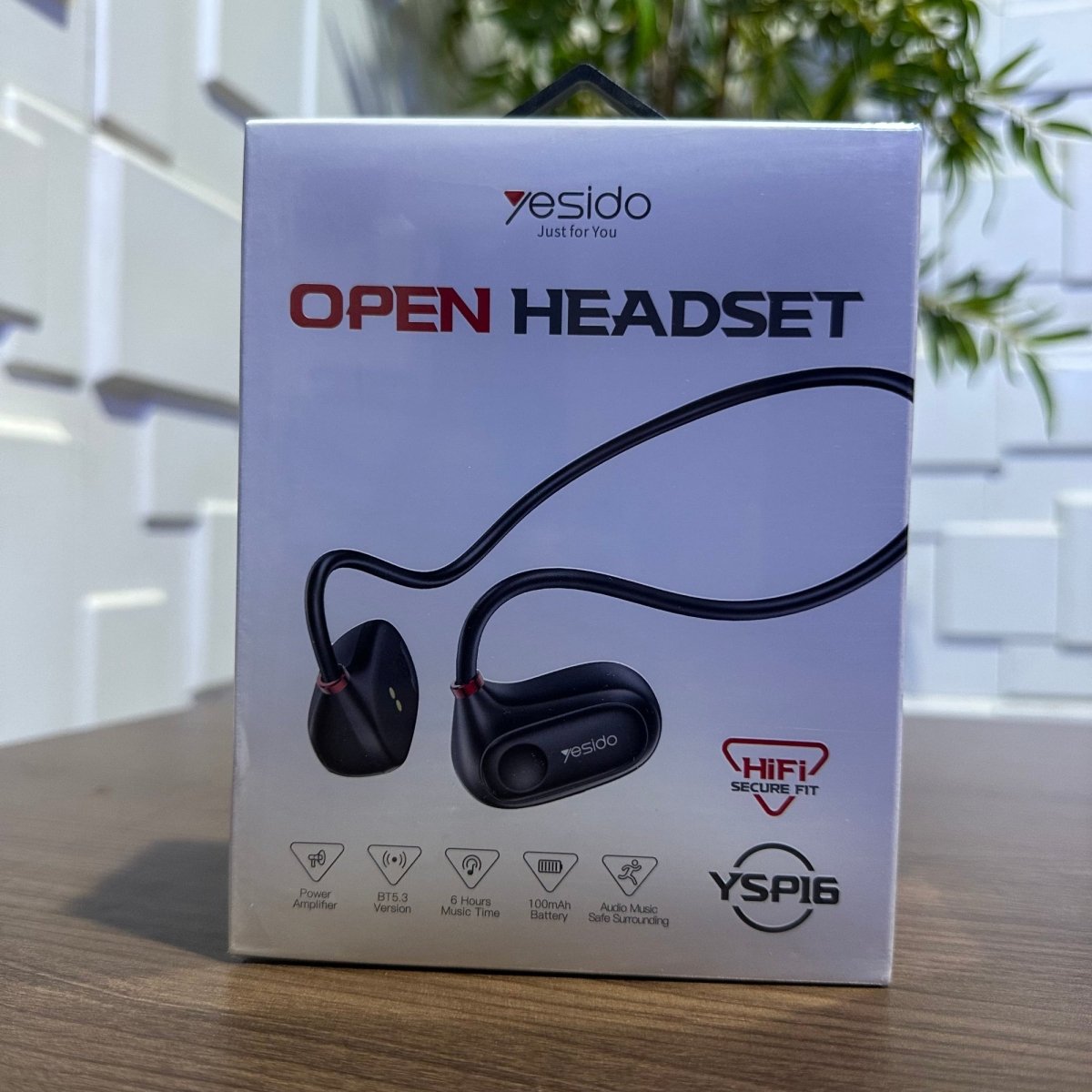 Yesido open headset packaging on a wooden surface with a blurred background