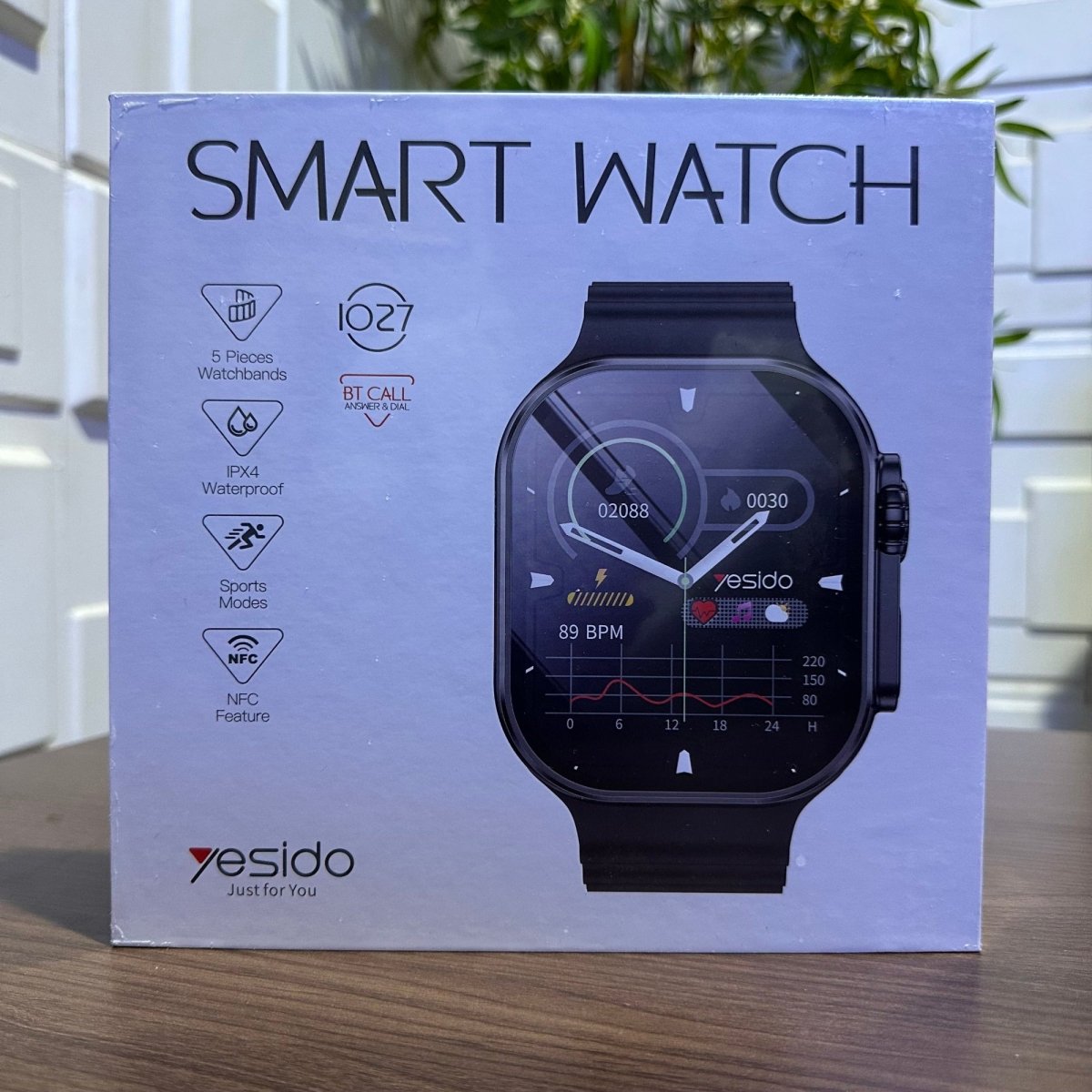 Box of a smart watch with Yesido branding on a wooden surface.