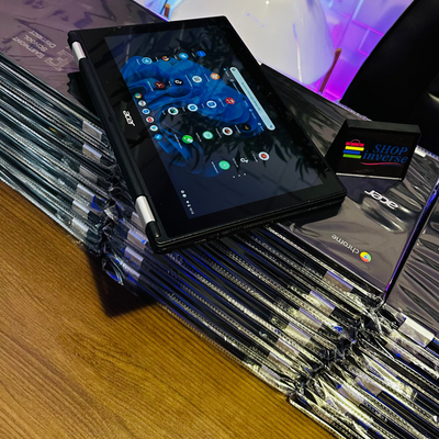 Stack of books with a tablet on top, colorful wall in the background