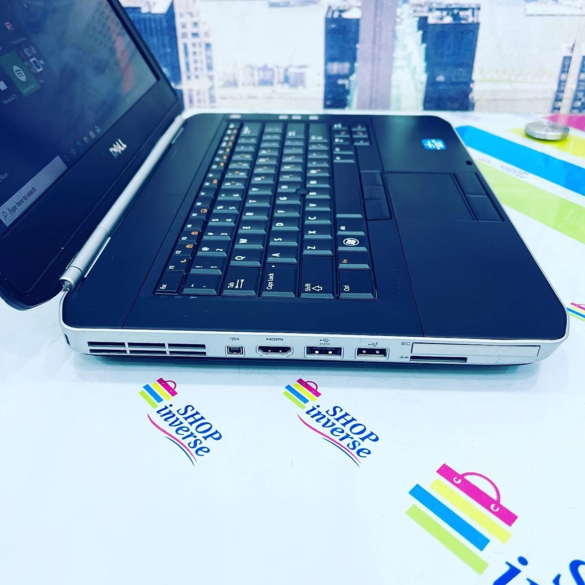 Laptop on a white surface with 'ShopInverse' logos.